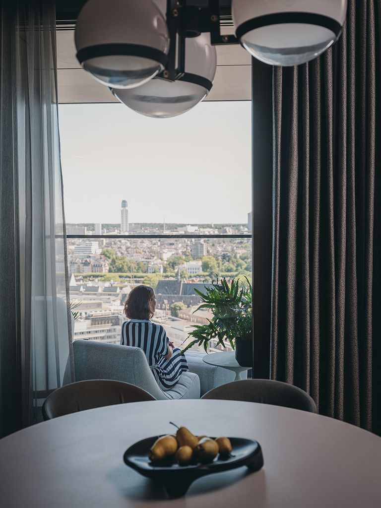 Woman in Frankfurt luxury apartment is happy about benefits